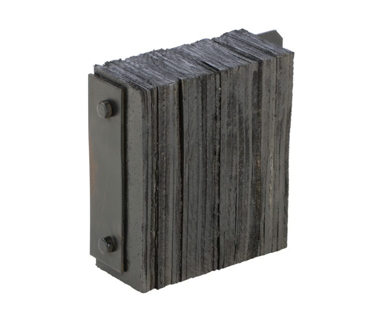 Dark, rectangular plates, akin to the Vestil Laminated Dock Bumper 12 X 14 X 4.5In, are secured by two side bolts forming a block shape. The uneven edges create a rugged texture.