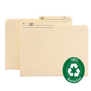 Two Smead 100% Recycled Reversible File Folders in manila, featuring 1/2-cut right printed tabs with spaces for NOM and NO, highlight their eco-friendly nature with a green recycling symbol. Available in legal size packs of 100 per box (15329).