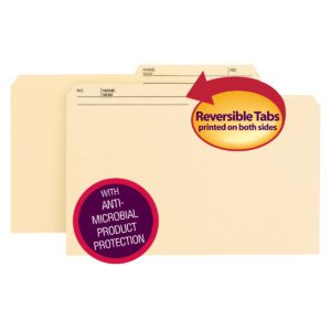 The Smead Reversible File Folder with Antimicrobial Protection features labeled tabs visible on both sides, perfect for organizing. The legal-size beige folders come 100 per box (15377), and a red and yellow arrow highlights the double-sided printed tabs feature.