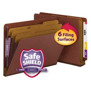 The set of brown folders features labeled tabs and reinforced edges, while the Smead End Tab Pressboard Classification File Folder in red (26865) includes 3 dividers and SafeSHIELD coated fasteners, highlighted with an arrow and 6 Filing Surfaces.