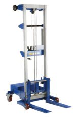 The blue and silver Vestil Winch Lift Truck Counter Balance 500 Lb features vertical railing, wheels, twin forks, and a cable & pulley lifting system. Its design includes both fixed and swivel casters for versatile mobility.