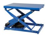 The Vestil Heavy Duty Air Bag Scissor Table 2K Lb has a blue rectangular platform and a robust square base. Its pneumatic components ensure smooth lifting and lowering, making it ideal for industrial use with heavy loads.
