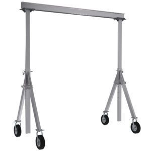 The Vestil Aluminum Gantry Crane W/Pnu Caster 15X12 features a rectangular beam, adjustable A-frame legs, and pneumatic caster wheels for easy mobility. Its silver structure includes visible wheel locking mechanisms for added safety.