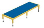 The Vestil Adj Steel Stand 10.5-16.5 H 24 X 72 is a rectangular table with a blue surface and yellow frame, featuring four adjustable legs with black feet, ideal for classrooms or workspaces, and displayed on a plain white background.