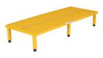 A yellow industrial step stool, similar to the Vestil Adj Steel Stand 10.5-16.5 H 23.5W X60L, has a textured non-slip surface and four rubber-capped legs for stability, ensuring safe access to elevated areas.