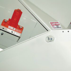 Close-up of a Vestil Corner Tilt Optional Power Vibration with a red lever and optional power functionality. The mainly white structure, adorned with caution labels and safety symbols, ensures efficient operation in demanding environments.
