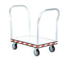 The Vestil Alum Treadplate Platform Trk 24X33 Dual Hdl features a robust metal platform with two vertical handles and four dark wheels. Its silver checkered treadplate design is enhanced by bold red and white striped edges, combining durability with style.