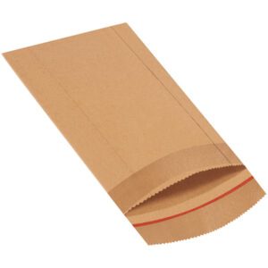 A clean and unused 7 1/4 x 10 1/2 Jiffy Rigi Bag® Mailer, ideal for mailing, lies flat on a white surface. It has a perforated red line near the top edge for easy tearing or folding, showcasing its sturdy design.