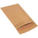 A brown paper envelope, similar to the 8 1/2 x 10 1/2 Lbs2 Jiffy Rigi Bag® Mailers, lies flat with its flap partially open on a white surface. The red adhesive strip is ready for sealing, and its natural texture suggests the expected durability of Lbs2 mailers.