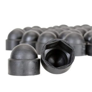 Close-up of Vestil Black Plastic Bolt Caps 1/2 In: multiple caps with rounded tops and hexagonal inner shapes. The foreground group shows the open side, while the background group is blurred.