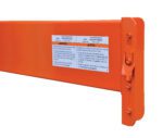 Close-up of the Vestil Pallet Racking Step Beam 7000 Lb 9 Ft, highlighting its orange color, safety warning label in English and Spanish, and a flat metal end with a mounting hole.