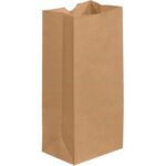 The 5 x 3 1/4 x 9 3/4 Kraft Grocery Bag stands upright with an open top, featuring a rectangular base and smooth texture. Ideal for storing groceries or lunch, its simplicity is highlighted against the white background, making it perfect for bulk use with packs of 500 per bundle.
