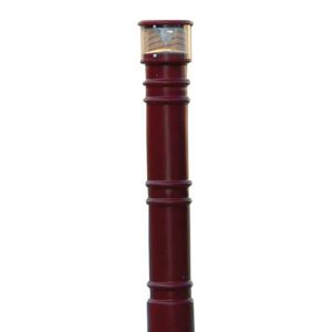 The Vestil Metro-Red Bollard Cover with Ac Light stands 57 inches high, featuring a transparent top section housing the light fixture. Its cylindrical design includes subtle ridges for decorative appeal, making it ideal for elegant outdoor lighting.