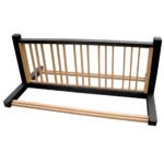 The disassembled wooden bed frame, with parallel slats and sturdy end supports, resembles the precise design of the Vestil Bike Rack Black/Cedar 10 Positions. It rests horizontally against a clean white background.