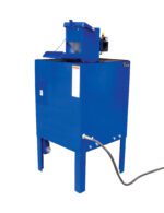 The blue Vestil Aerosol Can Puncturing System - Deluxe stands on four legs, with a top hopper, a cylindrical side attachment, and a black hose extending from the bottom. It includes warnings and indicator lights.
