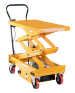 The bright yellow Vestil DC Power Hydr Scissor Cart 1K 39.75X20.5 is a hydraulic lift table with a scissor mechanism, featuring a flat platform, black handle, red caster wheels for mobility, and a visible side safety warning.