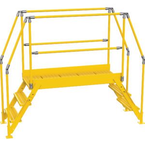 The Vestil Cross-Over Ladder 3 Step 28 H 50 W In features a bright yellow metal safety platform with railings and dual steps, designed for industrial use, providing sturdy handrails and a grated walking surface for stability.