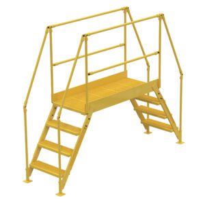 The Vestil Cross-Over Ladder 4 Step 38 H 50 W In features yellow metal stairs with railings and grated steps, offering a dual-step design to a sturdy platform for safe passage over obstacles in industrial settings.