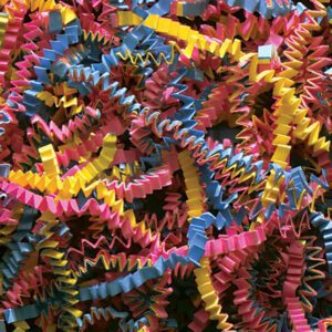The MH-USA 10 lb. Fiesta Blend Crinkle Paper forms a vibrant, chaotic zigzag pattern with intertwining blue, yellow, and pink strips that create a colorful and textured design.