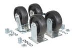 Four black rubber caster wheels with metal mounts, similar to the Vestil 6X2 Glass Filled Nylon Caster Kit 8000# Cap, are grouped together. Scattered around them on a white background are several metal bolts, nuts, and washers.