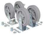 A set of Vestil 8X2 Thermoplastic Rubber (TPR) Kit2700# casters with metal brackets are lined up. Beside these sturdy casters, nuts, bolts, and washers lie scattered on the white surface, ready for assembly.