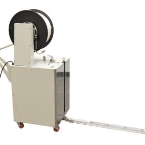 The Vestil Semi-Automatic Probe Strapping Machine is a portable white unit with wheels, featuring black strapping material on top. It includes a measuring-marked metal extension arm and an attached power cord for effective use.