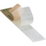A piece of 1 x 150 Clear 3M™ SJ4570 Dual Lock™ Low Profile Fasteners tape, featuring a brown backing, is partially peeled to reveal its sticky underside. The perforated texture and faint branding text are subtly highlighted on the brown surface.