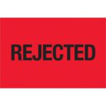 The image highlights a vibrant fluorescent red background with the word REJECTED boldly in black at the center, resembling MH-USA 2 x 3 - Rejected labels (Fluorescent Red) available in rolls of 500.