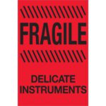 A fluorescent red sign with bold black text reads FRAGILE at the top, framed by diagonal lines, and warns of DELICATE INSTRUMENTS below. It resembles MH-USA 4 x 6 labels—Fluorescent Red: Fragile - Delicate Instruments, available in rolls of 500.