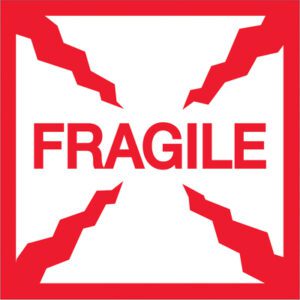 The MH-USA 2 x 2 - Fragile Labels (500/Roll) feature centered red text on a white background with jagged red borders, resembling cracked edges, ensuring your packages receive careful handling.