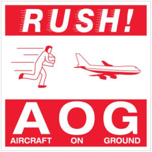 A vibrant red and white sign featuring RUSH! highlights a figure sprinting with a package beside a plane graphic. The bold AOG AIRCRAFT ON GROUND resembles the MH-USA 4 x 4 - Rush AOG - Aircraft On Ground Labels (500/Roll).