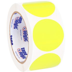 A roll of adhesive tape with the Tape Logic logo on the core has fluorescent yellow circles similar to MH-USA 2 Circles - Fluorescent Yellow Removable Labels (500/Roll), evenly placed on its clear surface.