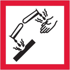 The MH-USA 1 x 1 Pictogram - Corrosion Labels (500/Roll) displays a test tube pouring liquid onto a corroding hand and surface, outlined in red on a white background.
