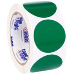 A roll of white tape decorated with large green dots resembles the MH-USA 2 Green Inventory Circle Labels (500/Roll), featuring an inner core marked with tape logic in bold blue and red text.
