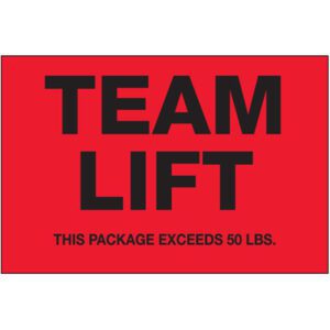 The vibrant MH-USA 2 x 3 - Team Lift fluorescent red labels with bold black text and a warning of THIS PACKAGE EXCEEDS 50 LBS. provide visibility and safety. They come in convenient rolls of 500.