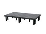 This minimalist coffee table, inspired by the Vestil Dunnage Rack Solid Top - 66 X 36, boasts a textured gray-black surface and multiple cylindrical black legs arranged in rows.