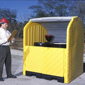 A man in a red hard hat inspects a Vestil Hard Top Drum Storage-4 Drum With Drain, featuring a curved, ribbed roof and barrels with funnels, against a backdrop of trees and clear sky.