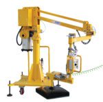 A yellow industrial robotic arm features multiple joints, a control panel, and is mounted on a wheeled base. Similar to the Vestil Air Bal Jib Lifter Floor Mount 47.25 In, it includes cables and a pneumatic cylinder for precise handling in manufacturing or assembly lines.