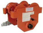 The Vestil Eye Manual Trolley Geared 10K Capacity showcases an orange industrial hoist with visible gears, chain, and a manufacturers label. It offers sturdy construction and a prominent warning label for safe heavy lifting.