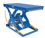 The Vestil Electric Hydraulic Lift Table 3K 30X72 has a blue X-shaped base, a flat rectangular top with yellow safety edges, and a hydraulic cylinder with side cable for effortless lifting.