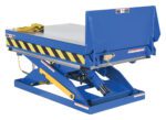 The Vestil Lift & End Tilt Scissor Table 2K 36X48 includes a blue hydraulic lift with a rectangular platform marked by yellow and black safety stripes, a coiled yellow control cord, and a sturdy base with hydraulic components for smooth lifting and lowering functions.