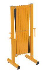 The orange folding barricade, similar to the Vestil Steel Expand-A-Gate 15 To 144 In Width, stands vertically with multiple horizontal slats in a sturdy frame. It has side handles and rests folded on a flat surface, expandable from 15 to 144 inches in width.