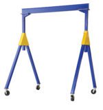 The Vestil Fixed Ht. Stl Gantry Crane 10K 15Ft Kd is a sturdy blue and yellow crane with four telescopic legs on wheels, perfect for moving heavy loads in industrial environments.