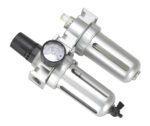 The Vestil Air Filter-Lube Regulator Port Hole 1/2 boasts a silver pneumatic design with twin cylinders, a black pressure gauge, transparent caps, and connecting pipes, providing superior air pressure control and adjustment in pneumatic systems.