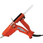 The orange 3M™ Hot Melt Applicator, known as Polygun LT, has a rear glue stick slot and a black power cord from the handle. With its trigger mechanism and metal stand for stability, it is an efficient tool for crafting.