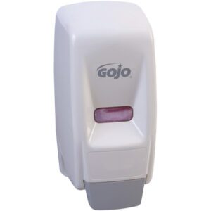 The GOJO® Wall-Mount Dispenser - 800 mL, White, boasts a sleek design featuring the brand name on the front. A rectangular window reveals pink soap inside, all set against a stylish gray base.