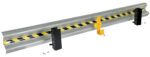 The Vestil Guard Rail System Drop In Rail 111 In includes a metal guardrail section with black and yellow striped tape, supported by two black brackets and a yellow bracket. It comes with bolts and screws for secure installation.