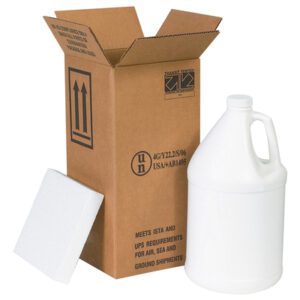 An open MH-USA 6 x 6 x 12 3/4 Shipper Kit reveals a white plastic jug. A piece of white foam leans against the box, which displays shipping symbols and text for the one-gallon jug inside.