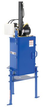 The Vestil Hydraulic Pail Crusher 5 Gallon features a blue industrial upright design with a black hydraulic cylinder on top. It includes a white 5-gallon container, various labels, four sturdy legs for support, and a front door for easy access.