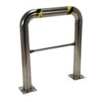 The Vestil Ss High Profile Rack Guard 36 x 42 x 4 inches includes a stainless steel barrier with a curved top, striped in black and yellow diagonals, supported by two posts with holes in the bases for secure mounting.